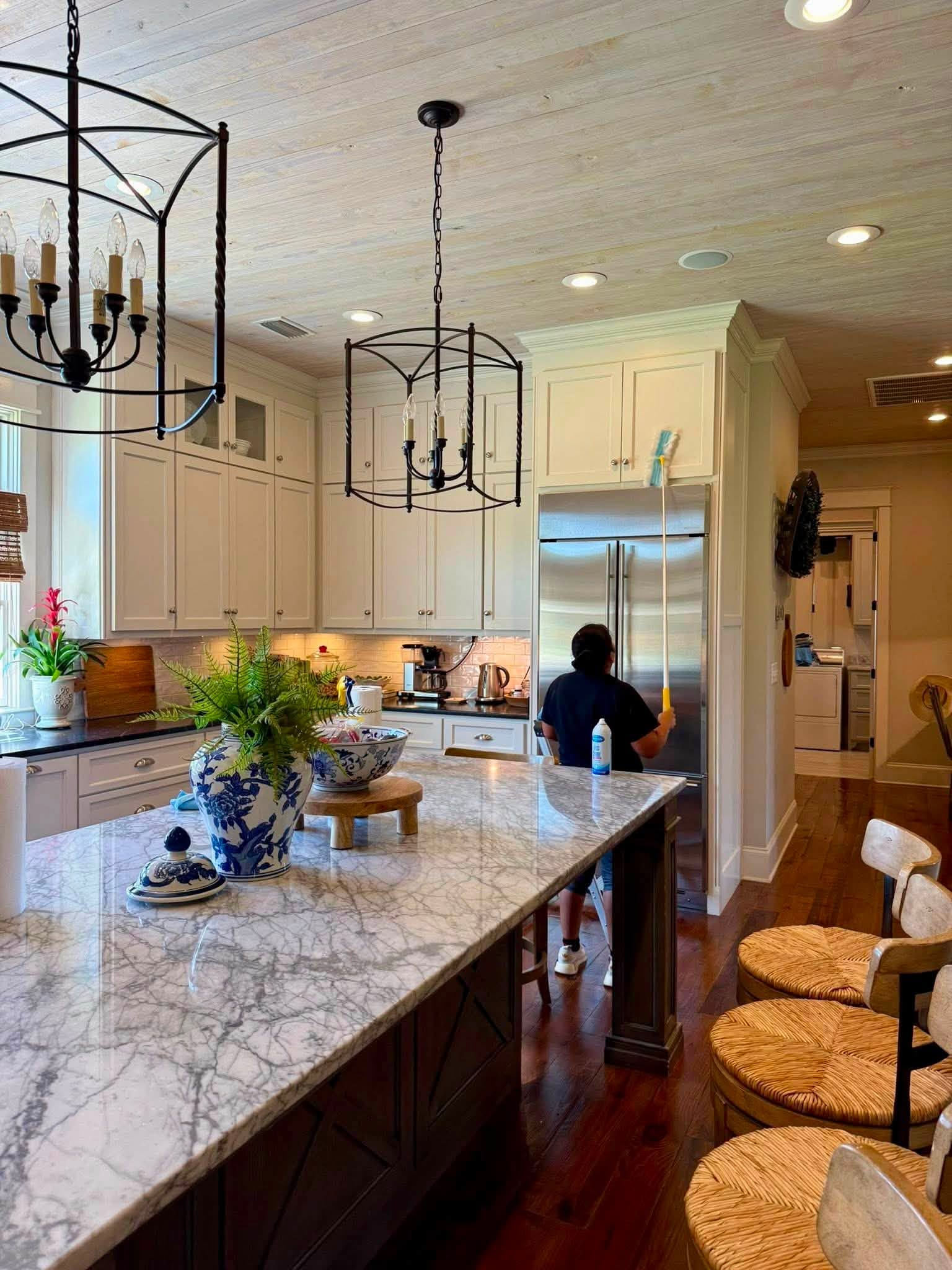 Team member dusting a kitchen